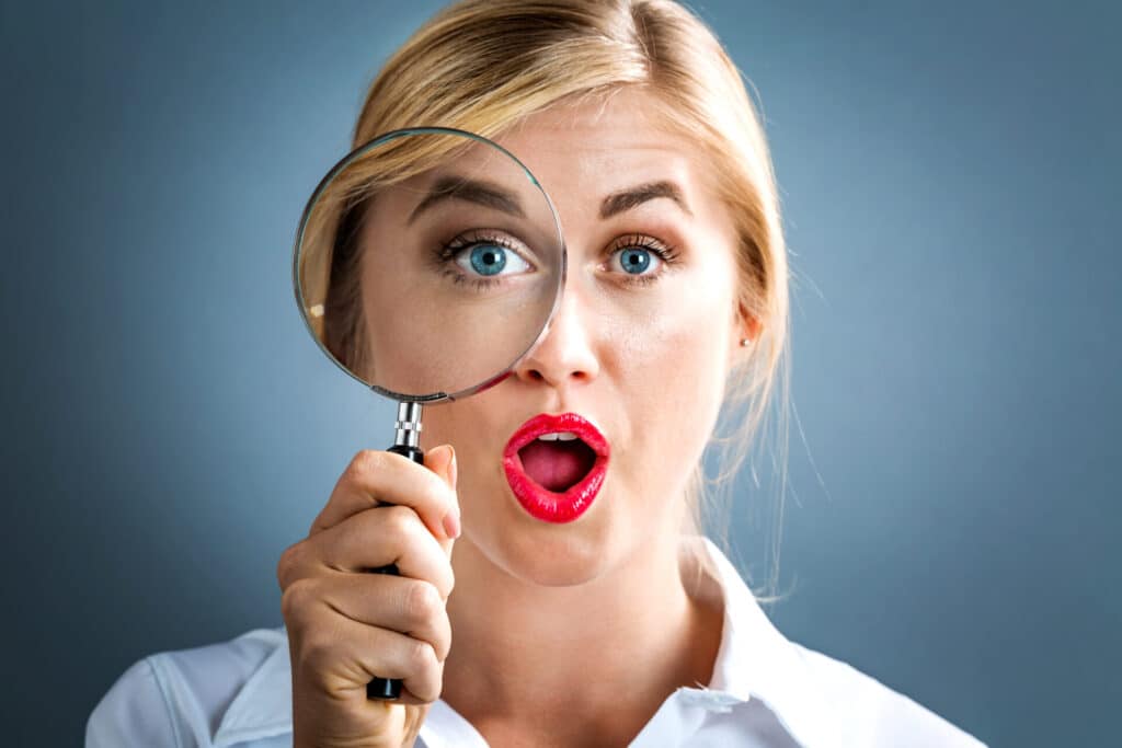 Woman holding magnifying glass